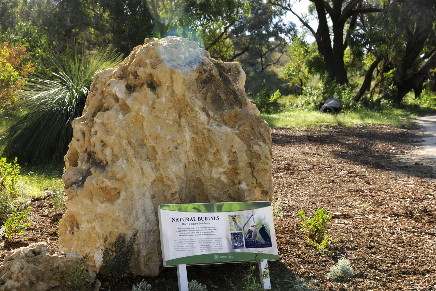 Natural Burials sign in front of boulder at Pinnaroo Valley Memorial Park