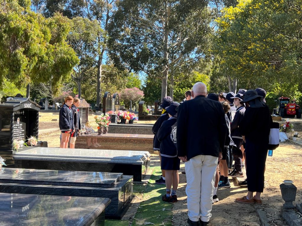 The students from Freshwater Bay presented their research to the group before commemorating the fallen servicemen with a decorated wooden cross.